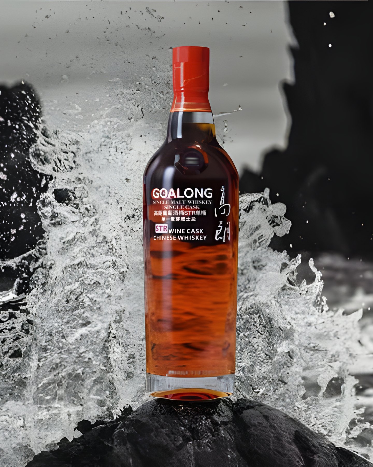 A bottle of Goalong Single Malt Whiskey on a sea rock in a splash of water